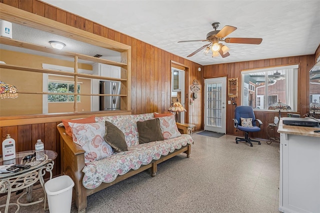 1085 Indigo Rd, Ormond Beach, FL 32174 - living area featuring wooden walls, healthy amount of natural light, and ceiling fan