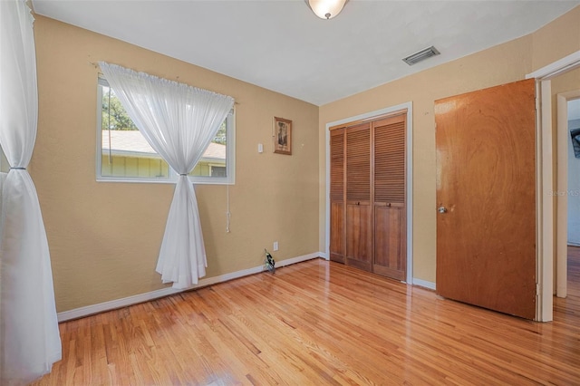 1085 Indigo Rd, Ormond Beach, FL 32174 - unfurnished bedroom featuring wood finished floors and a closet