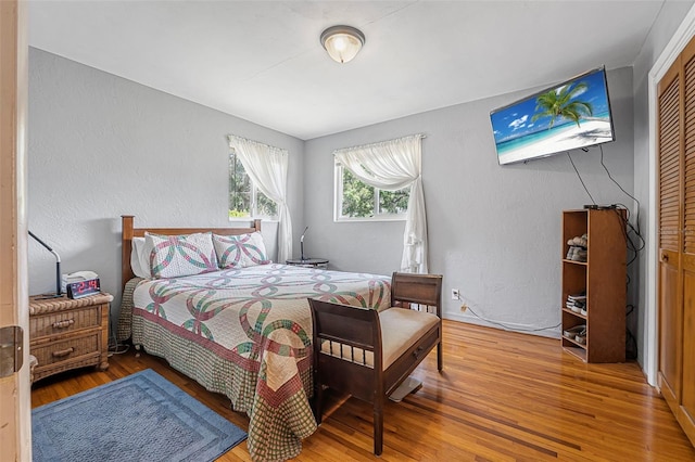 1085 Indigo Rd, Ormond Beach, FL 32174 - bedroom featuring wood finished floors, a closet, and a textured wall