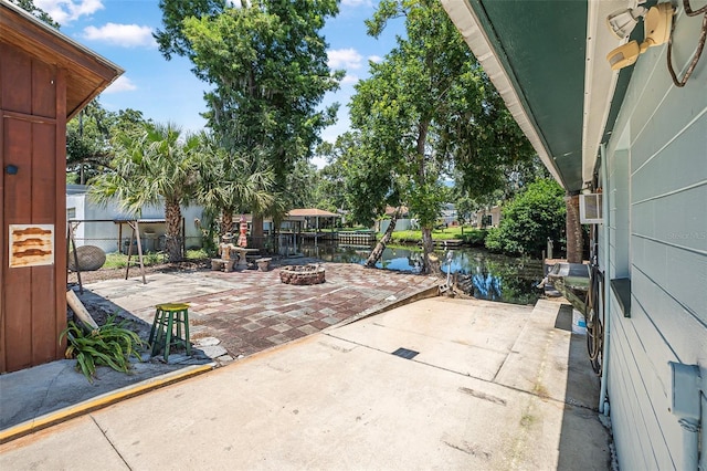 1085 Indigo Rd, Ormond Beach, FL 32174 - view of patio featuring a water view and a fire pit