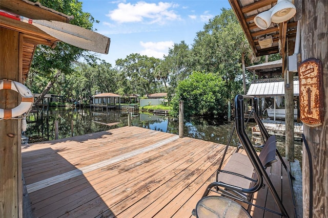 1085 Indigo Rd, Ormond Beach, FL 32174 - dock with a water view, boat lift, and view of wooded area