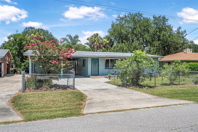 1085 Indigo Rd, Ormond Beach, FL 32174 - ranch-style home with driveway, a metal roof, and a carport