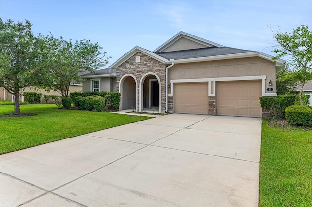 32 Abacus Ave, Ormond Beach, FL 32174 - view of front of house featuring stone siding, a garage, stucco siding, a front yard, and driveway