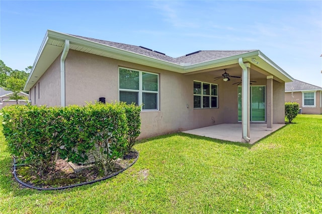 32 Abacus Ave, Ormond Beach, FL 32174 - rear view of house featuring stucco siding, ceiling fan, a patio area, and a yard