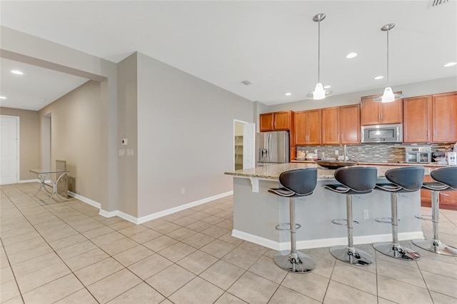 32 Abacus Ave, Ormond Beach, FL 32174 - kitchen featuring stainless steel appliances, tasteful backsplash, recessed lighting, a breakfast bar area, and light tile patterned floors