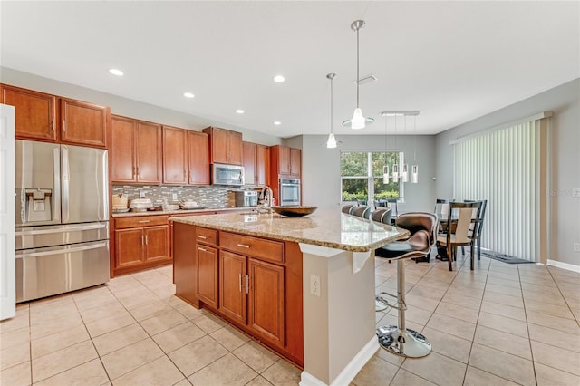 32 Abacus Ave, Ormond Beach, FL 32174 - kitchen featuring stainless steel appliances, light tile patterned flooring, decorative backsplash, a kitchen bar, and recessed lighting