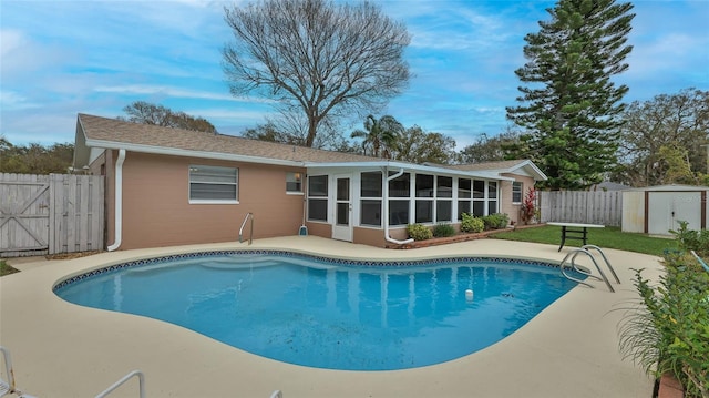 2970 Lantern Dr, South Daytona, FL 32119 - view of swimming pool with a storage shed, a sunroom, a fenced backyard, and a patio area