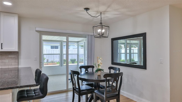 2970 Lantern Dr, South Daytona, FL 32119 - dining area with light wood-style floors, a chandelier, and a textured ceiling