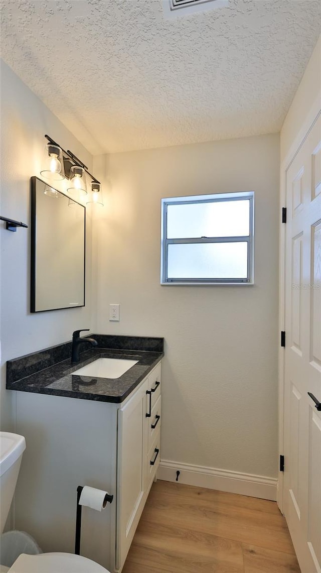 2970 Lantern Dr, South Daytona, FL 32119 - bathroom with vanity, wood finished floors, and a textured ceiling