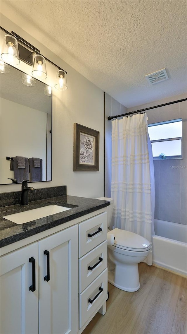 2970 Lantern Dr, South Daytona, FL 32119 - bathroom with wood finished floors, vanity, a textured ceiling, and shower / bathtub combination with curtain