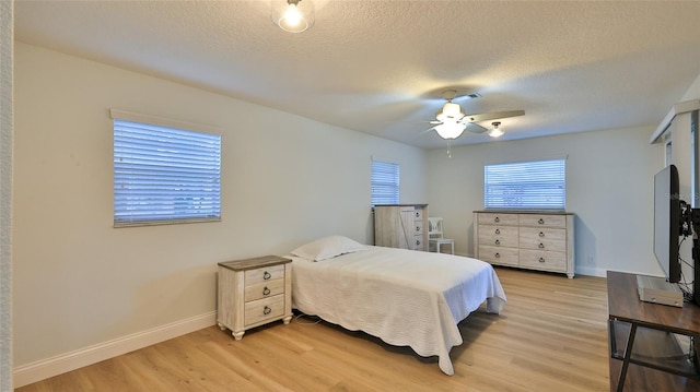 2970 Lantern Dr, South Daytona, FL 32119 - bedroom featuring light wood finished floors, ceiling fan, and a textured ceiling