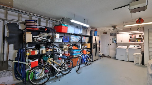 2970 Lantern Dr, South Daytona, FL 32119 - garage featuring washing machine and clothes dryer, a garage door opener, stainless steel refrigerator with ice dispenser, and ceiling fan