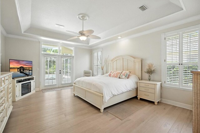 19 Tomoka Cove Way, Ormond Beach, FL 32174 - bedroom with a tray ceiling, access to exterior, light wood-style floors, ornamental molding, and a ceiling fan