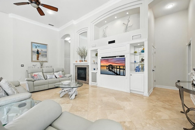 19 Tomoka Cove Way, Ormond Beach, FL 32174 - living room with built in shelves, ornamental molding, a ceiling fan, arched walkways, and recessed lighting