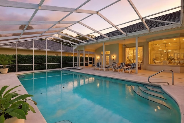 19 Tomoka Cove Way, Ormond Beach, FL 32174 - pool at dusk with a patio area and glass enclosure