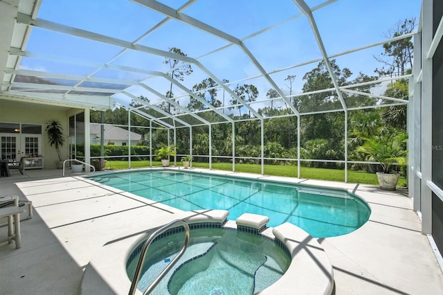 19 Tomoka Cove Way, Ormond Beach, FL 32174 - view of pool featuring a pool with connected hot tub, a patio, and glass enclosure