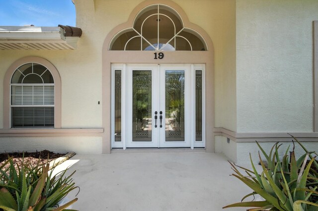 19 Tomoka Cove Way, Ormond Beach, FL 32174 - doorway to property featuring french doors and stucco siding