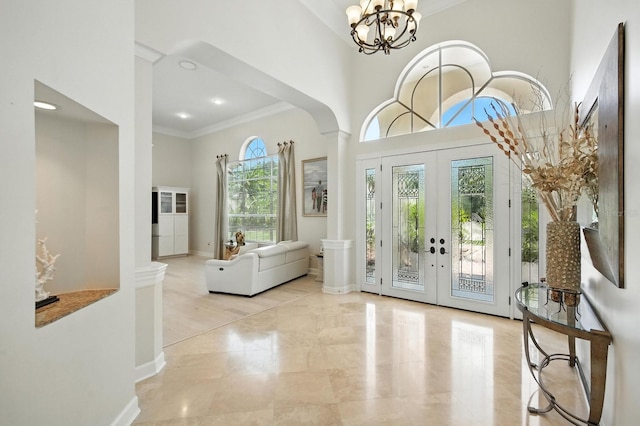 19 Tomoka Cove Way, Ormond Beach, FL 32174 - entryway featuring crown molding, decorative columns, a high ceiling, french doors, and marble tiled flooring