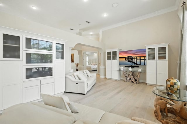 19 Tomoka Cove Way, Ormond Beach, FL 32174 - living room featuring crown molding, arched walkways, light wood-type flooring, and recessed lighting