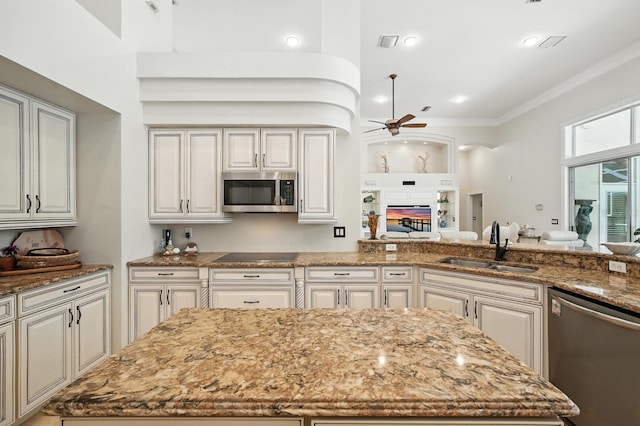 19 Tomoka Cove Way, Ormond Beach, FL 32174 - kitchen featuring appliances with stainless steel finishes, ceiling fan, light stone counters, crown molding, and a fireplace