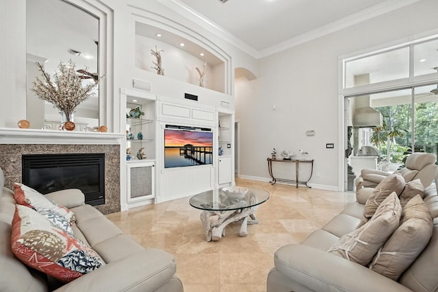 19 Tomoka Cove Way, Ormond Beach, FL 32174 - living area featuring ornamental molding, a towering ceiling, a high end fireplace, built in shelves, and recessed lighting