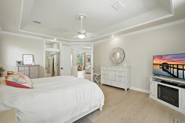 19 Tomoka Cove Way, Ormond Beach, FL 32174 - bedroom with a raised ceiling, ornamental molding, light wood-type flooring, arched walkways, and a ceiling fan
