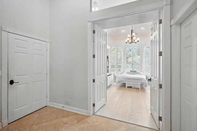 19 Tomoka Cove Way, Ormond Beach, FL 32174 - tiled bedroom with a chandelier and radiator heating unit
