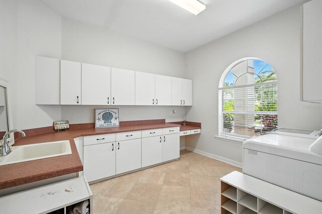 19 Tomoka Cove Way, Ormond Beach, FL 32174 - laundry room featuring independent washer and dryer, cabinet space, light tile patterned flooring, and an office area