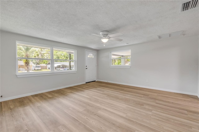 173 Cedar Ave, Orange City, FL 32763 - empty room featuring a ceiling fan, a textured ceiling, and light wood finished floors