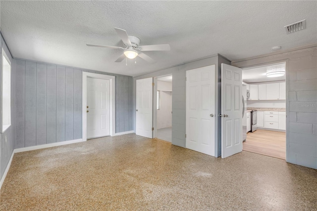 173 Cedar Ave, Orange City, FL 32763 - unfurnished bedroom with a textured ceiling, ceiling fan, and connected bathroom