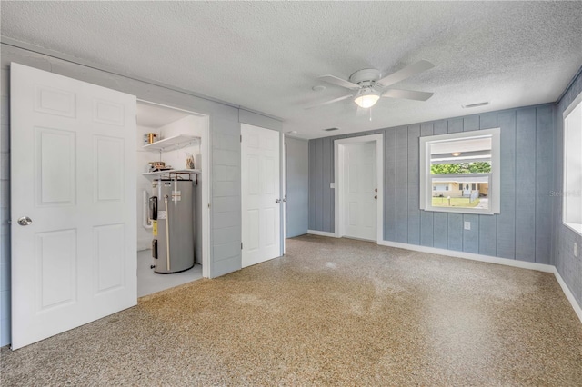 173 Cedar Ave, Orange City, FL 32763 - unfurnished bedroom featuring water heater, a textured ceiling, and a ceiling fan