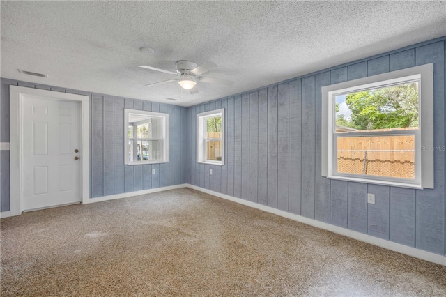 173 Cedar Ave, Orange City, FL 32763 - unfurnished room with ceiling fan, carpet, a textured ceiling, and wood walls
