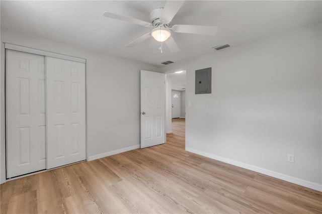 173 Cedar Ave, Orange City, FL 32763 - unfurnished bedroom with electric panel, light wood-type flooring, a closet, and a ceiling fan