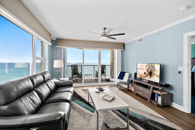 3315 S Atlantic Ave Unit 1605, Daytona Beach Shores, FL 32118 - living area with wood finished floors, ceiling fan, crown molding, a water view, and healthy amount of natural light
