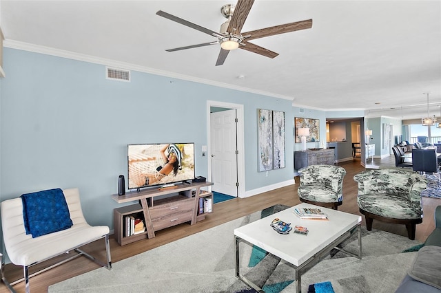 3315 S Atlantic Ave Unit 1605, Daytona Beach Shores, FL 32118 - living room with ornamental molding, a ceiling fan, and wood finished floors