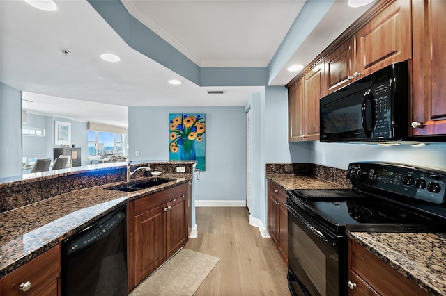 3315 S Atlantic Ave Unit 1605, Daytona Beach Shores, FL 32118 - kitchen with black appliances, light wood-type flooring, dark stone counters, and recessed lighting