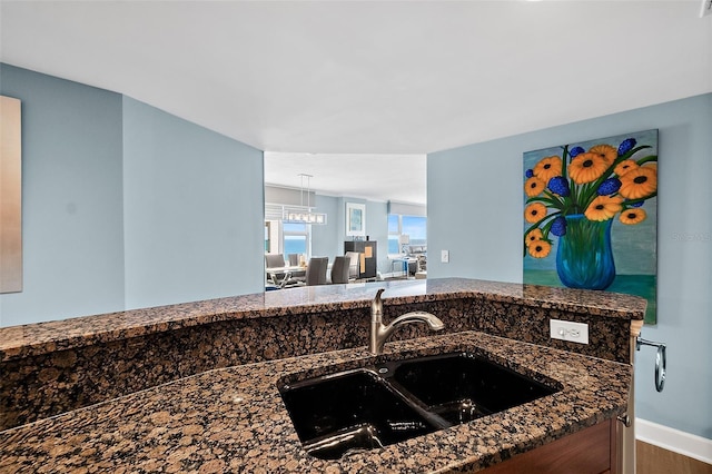 3315 S Atlantic Ave Unit 1605, Daytona Beach Shores, FL 32118 - kitchen with wood finished floors and dark stone countertops