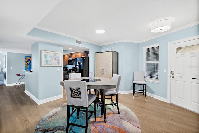 3315 S Atlantic Ave Unit 1605, Daytona Beach Shores, FL 32118 - dining room featuring wood finished floors and ornamental molding