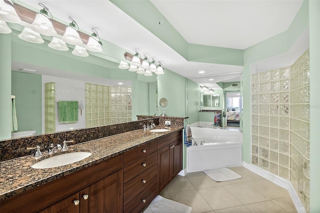 3315 S Atlantic Ave Unit 1605, Daytona Beach Shores, FL 32118 - bathroom with a garden tub, tile patterned floors, double vanity, and a tile shower