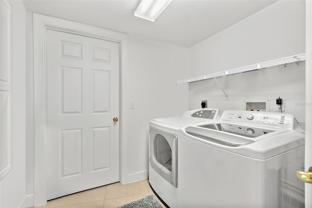 3315 S Atlantic Ave Unit 1605, Daytona Beach Shores, FL 32118 - washroom featuring washing machine and clothes dryer and light tile patterned flooring