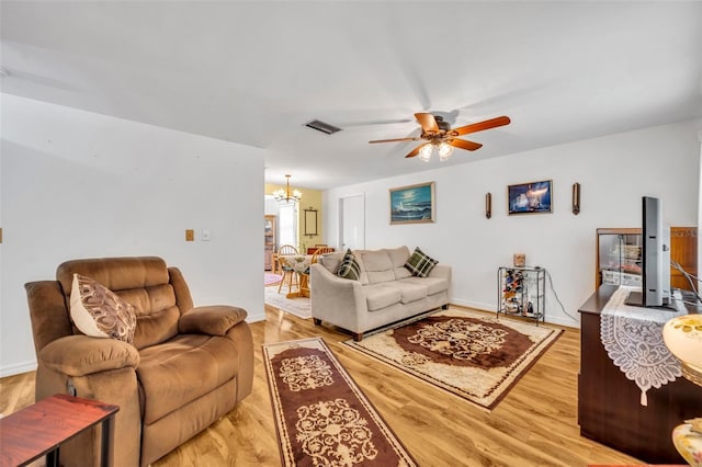 2468 Kimberly Dr, Deltona, FL 32738 - living room with a chandelier, light wood finished floors, and ceiling fan
