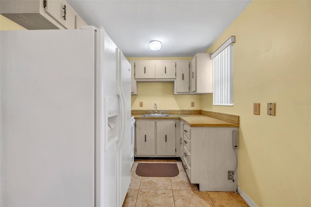 2468 Kimberly Dr, Deltona, FL 32738 - kitchen featuring white refrigerator with ice dispenser, light countertops, and light tile patterned flooring