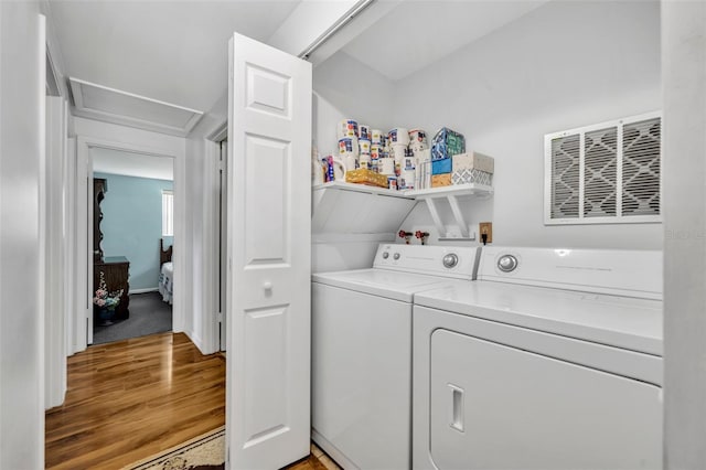 2468 Kimberly Dr, Deltona, FL 32738 - washroom with washer and dryer, light wood-type flooring, and attic access