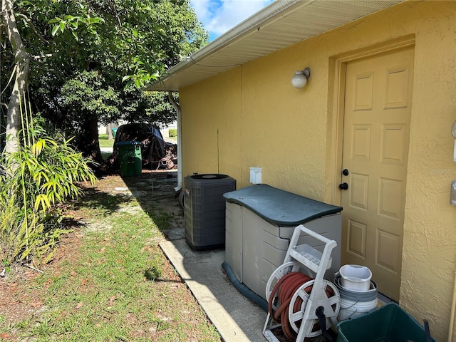 1887 Viking Ave, Deltona, FL 32725 - view of property exterior with a central AC unit and stucco siding