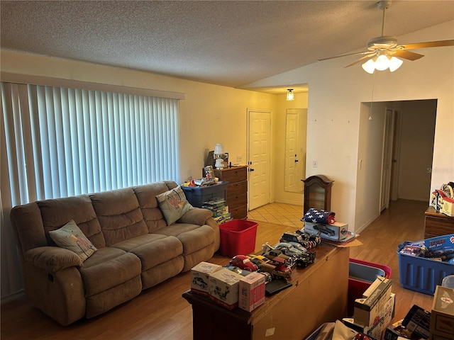 1887 Viking Ave, Deltona, FL 32725 - living room featuring wood finished floors, a ceiling fan, lofted ceiling, and a textured ceiling