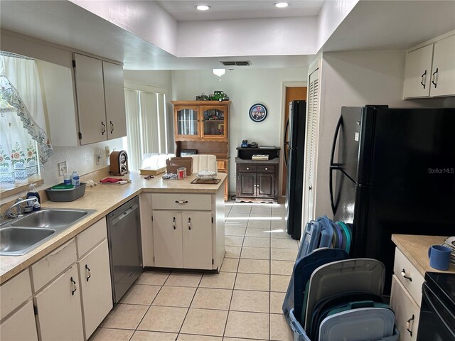 1887 Viking Ave, Deltona, FL 32725 - kitchen with dishwasher, freestanding refrigerator, light tile patterned floors, light countertops, and recessed lighting