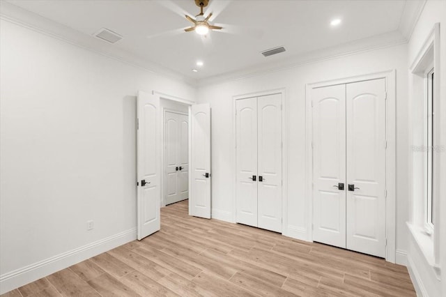 4885 State Road 11, De Leon Springs, FL 32130 - unfurnished bedroom with multiple closets, ornamental molding, light wood-style floors, recessed lighting, and ceiling fan