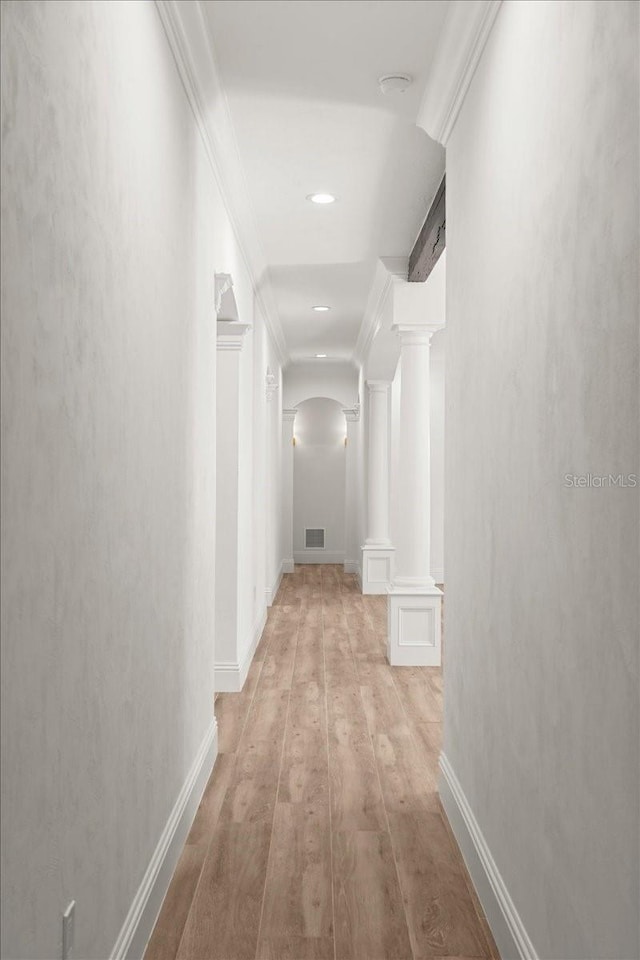 4885 State Road 11, De Leon Springs, FL 32130 - corridor featuring arched walkways, ornate columns, ornamental molding, wood finished floors, and recessed lighting