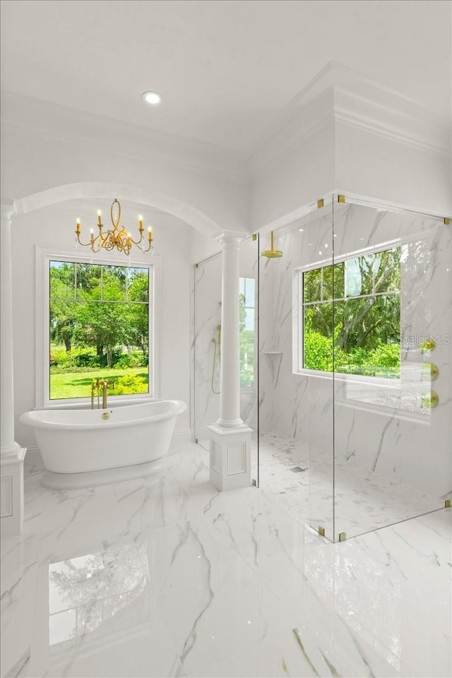 4885 State Road 11, De Leon Springs, FL 32130 - bathroom with ornate columns, a freestanding tub, a marble finish shower, ornamental molding, and a chandelier