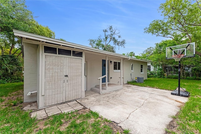 182 Grove St, Ormond Beach, FL 32174 - back of property with a lawn, a patio, and concrete block siding